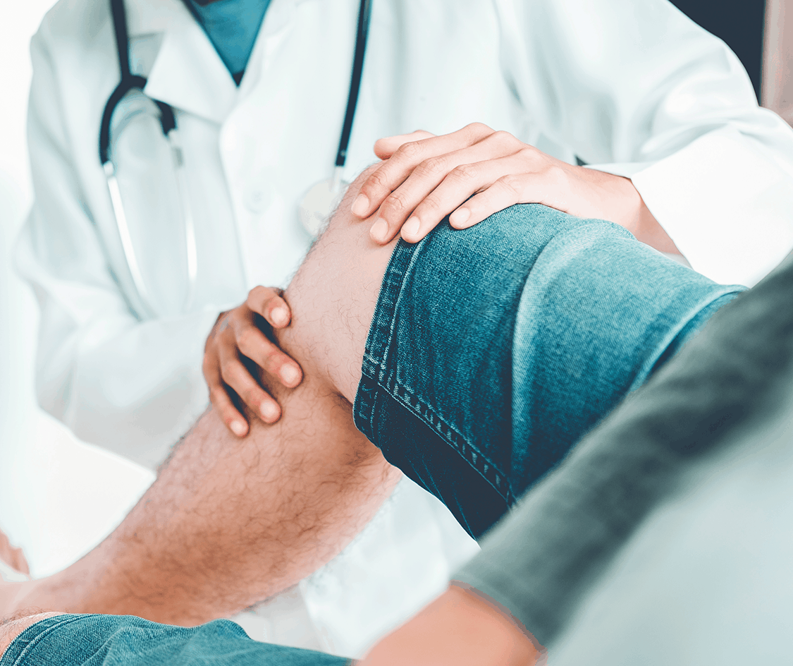 Medical professional examining patient knee 