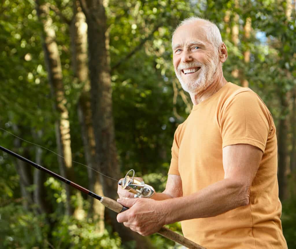 Portrait of healthy smiling bearded Caucasian male pensioner in
