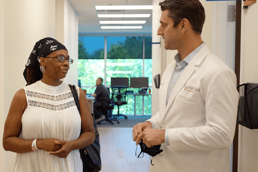 Dr. Joseph W. Greene, M.D., consults with hip replacement patient about her surgery.