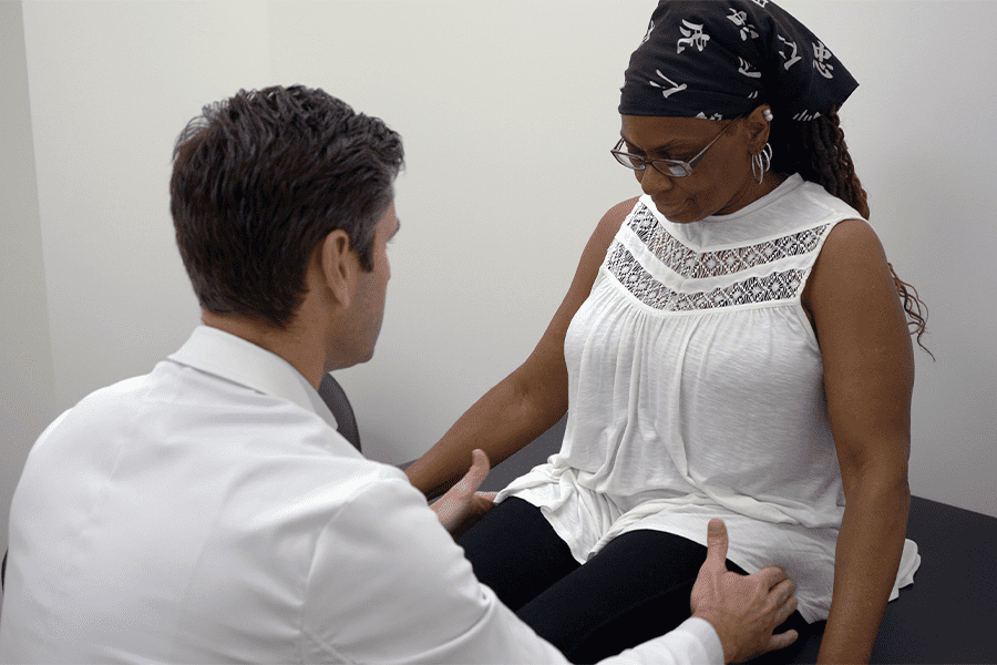 Dr. Joseph W. Greene, M.D., examines his hip replacement patient after her surgery.