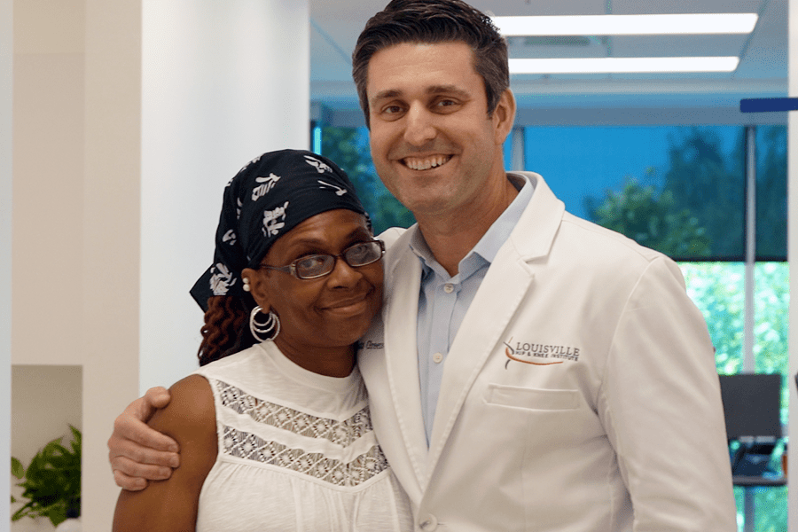 Dr. Joseph W. Greene, M.D., poses for a picture with his hip replacement patient, Valencia.
