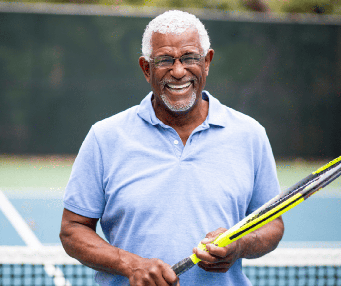 senior man with tennis racket