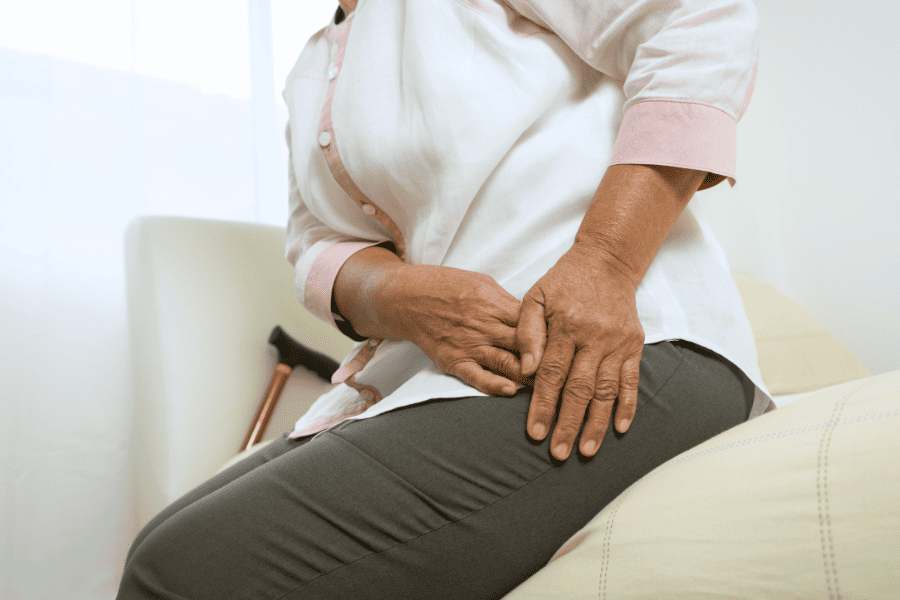woman holding hip in disconfort due to Subluxation