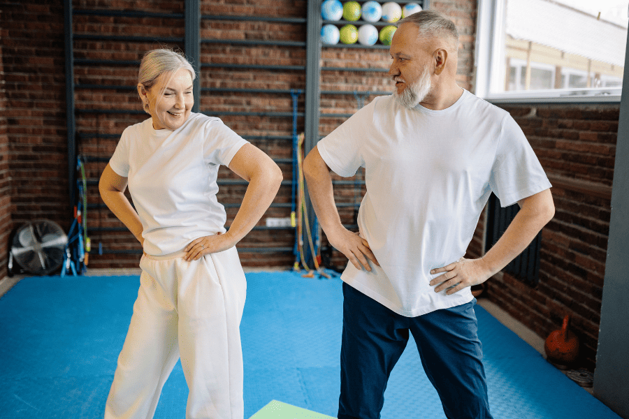 Senior couple doing hip exercises
