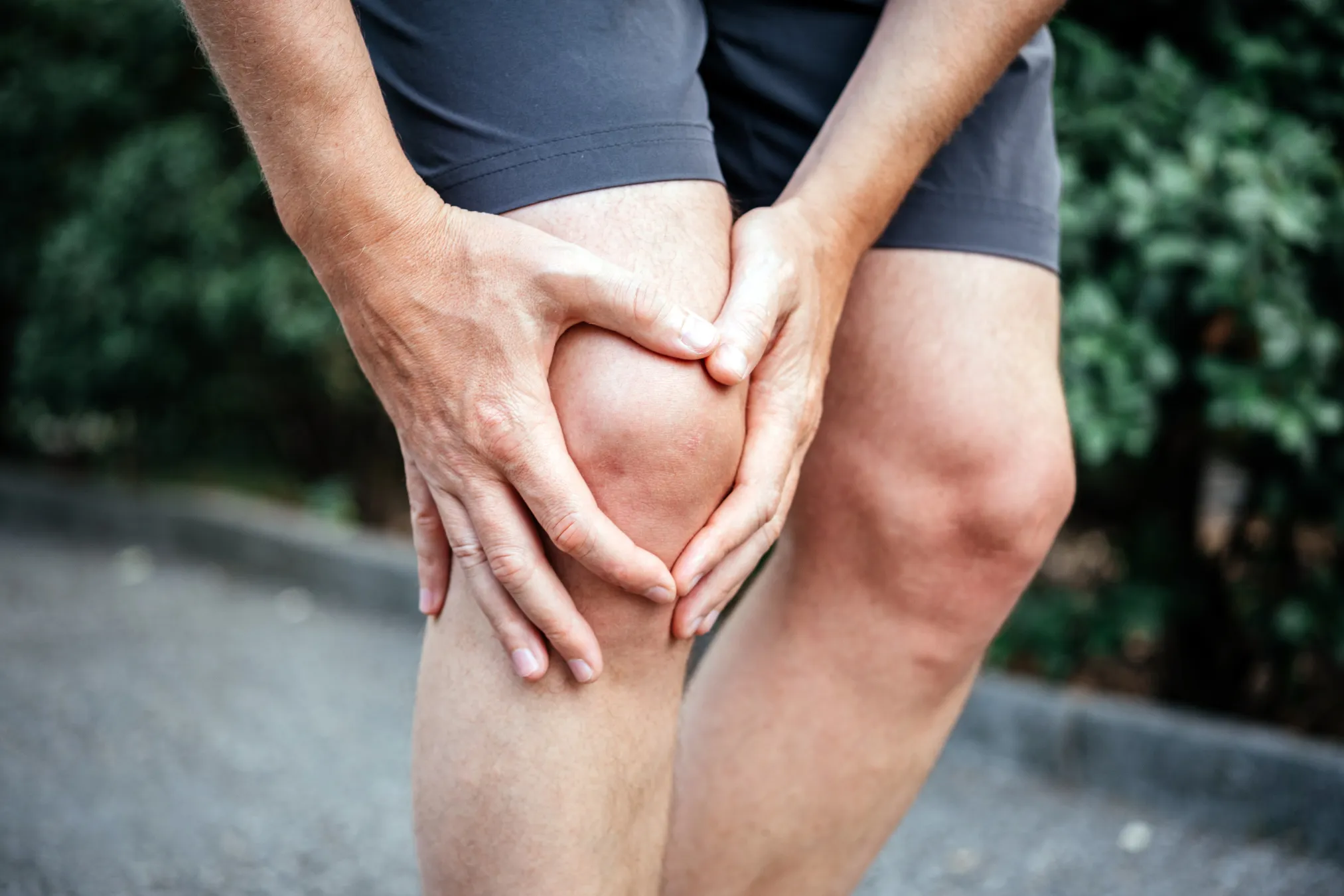 Man holding knee