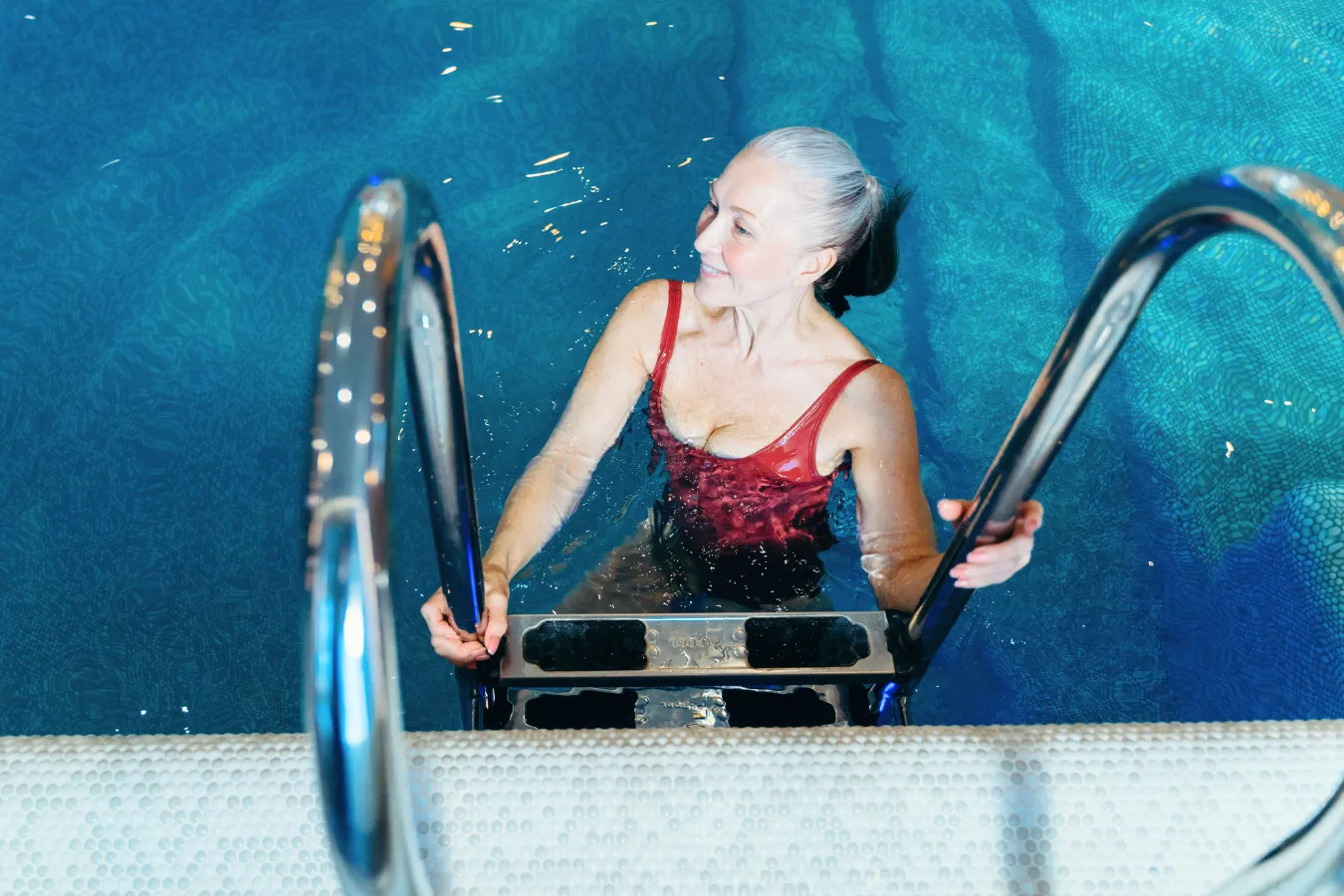 Woman getting out of a swimming pool